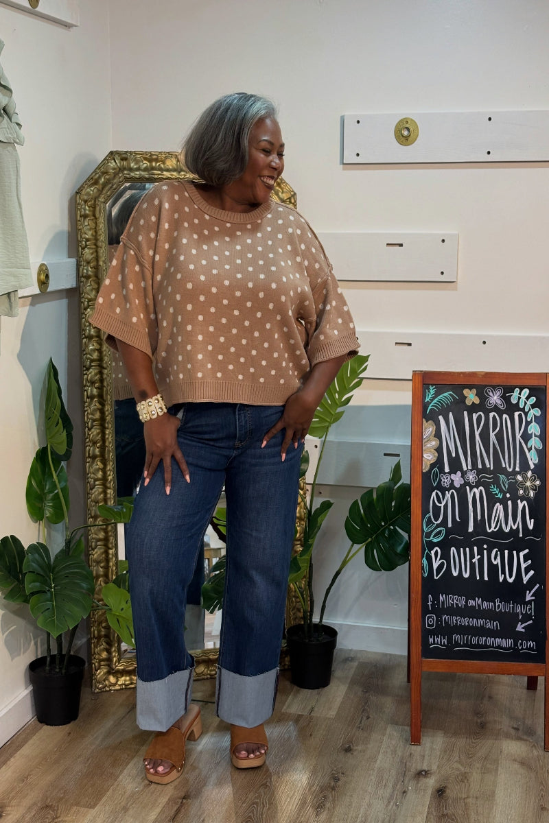 Woman wearing a camel and ivory polka dot short sleeve knit sweater top with round neckline and ribbed trim — Mirror on Main