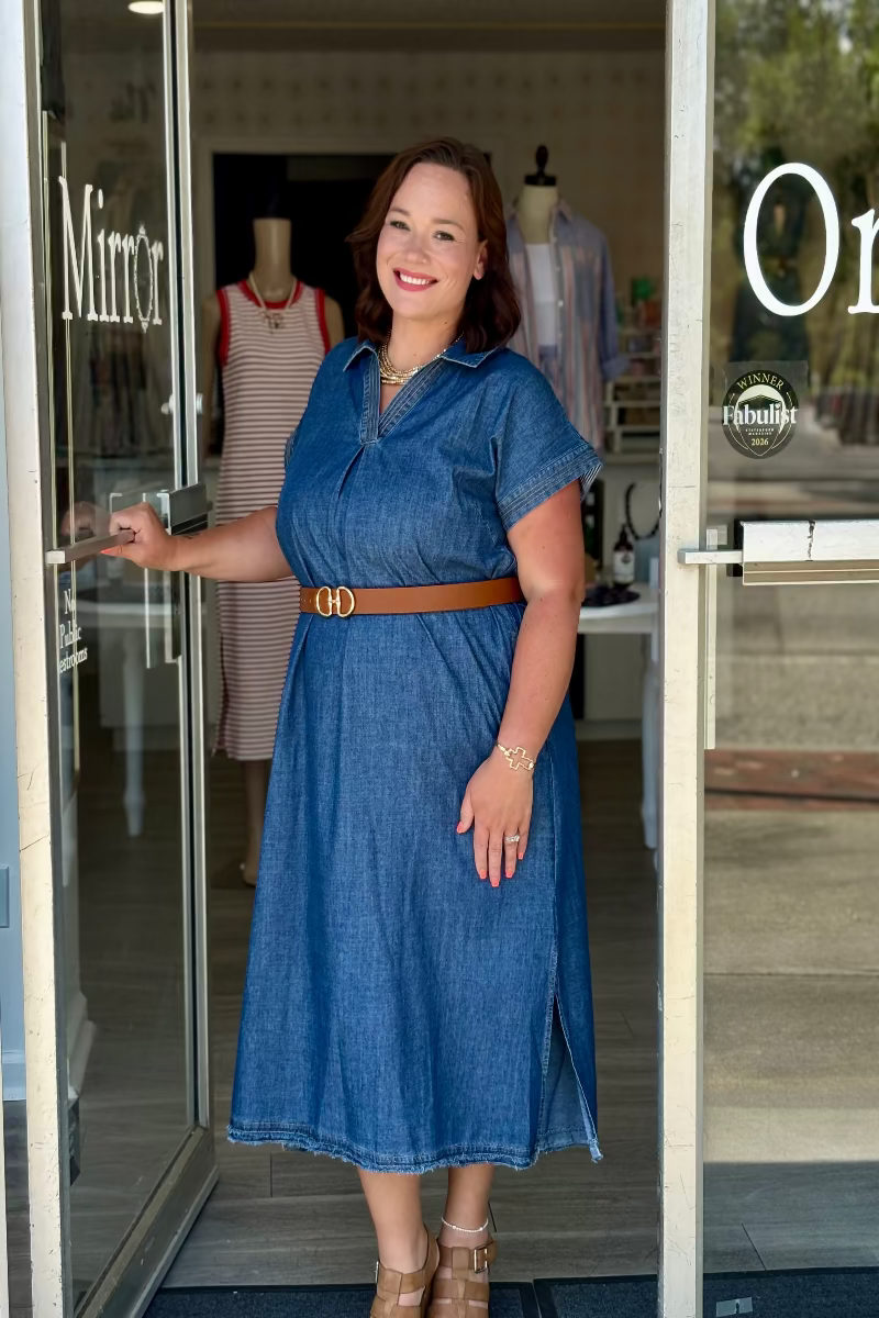 Woman wearing a blue denim dress in front of Mirror On Main