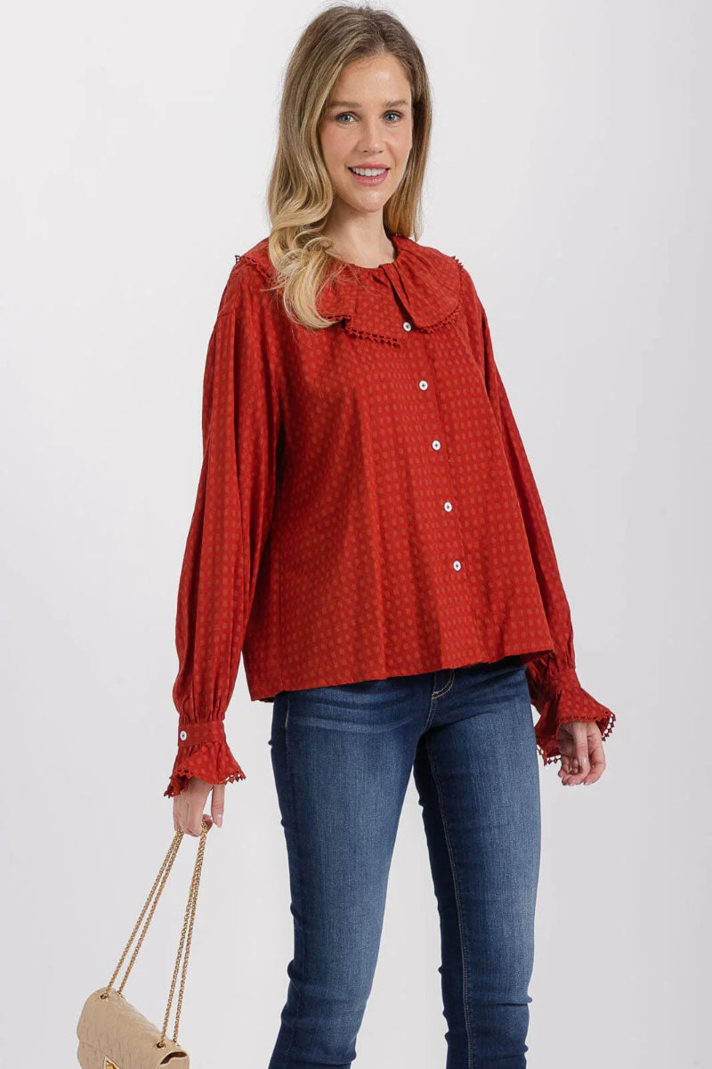 Woman wearing a red checkered blouse and blue jeans on a white background