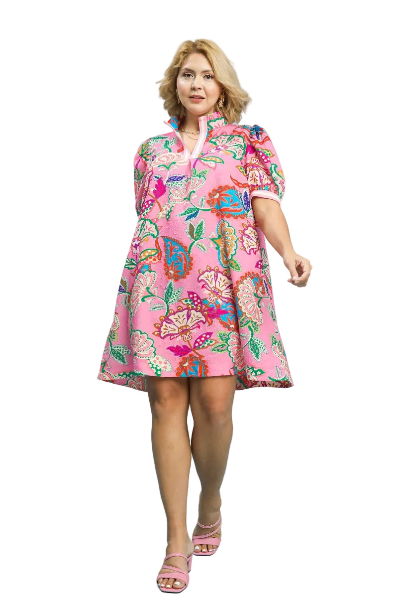 Plus size woman wearing a pink jacquard mini dress with tropical paisley print, split V-neck, and puff sleeves — Mirror on Main
