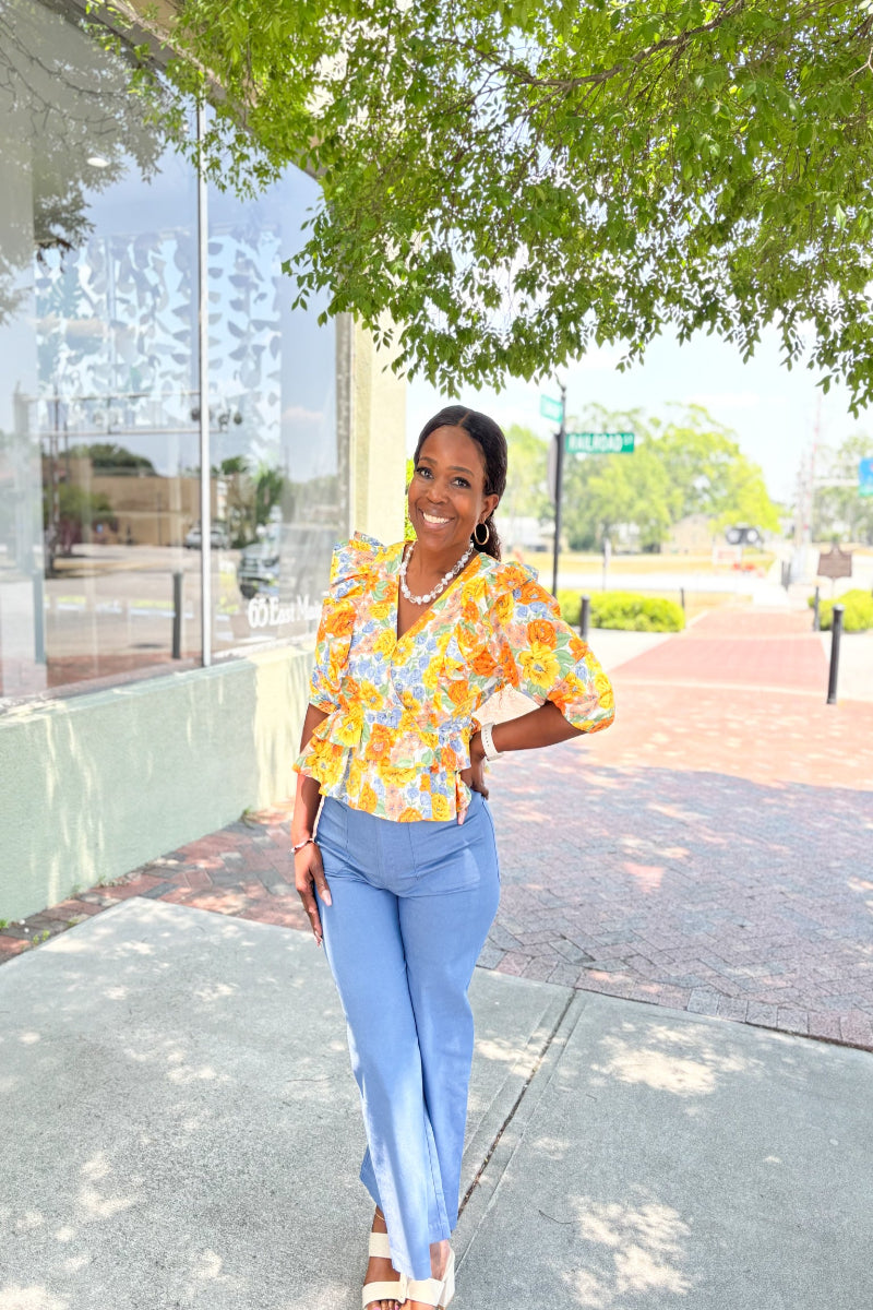 floral ruffle peplum top in multiple colors styled with white shorts for spring outfit