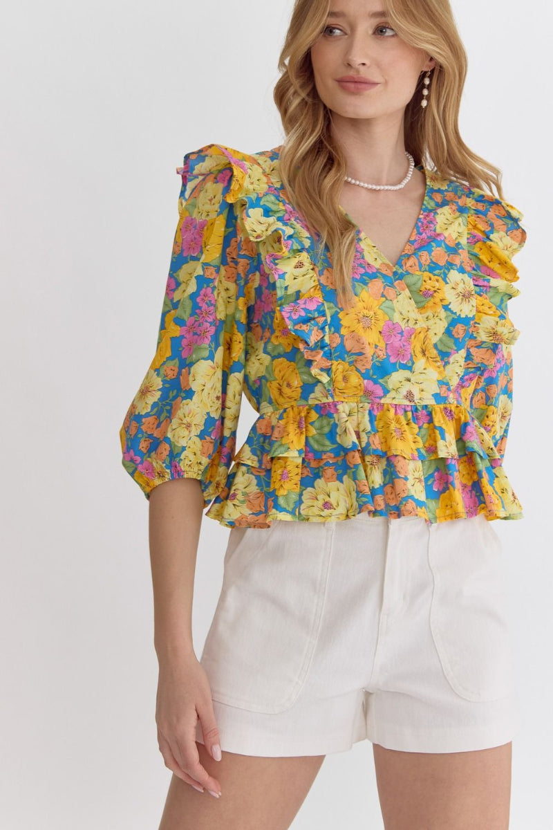 floral ruffle peplum top in multiple colors styled with white shorts for spring outfit