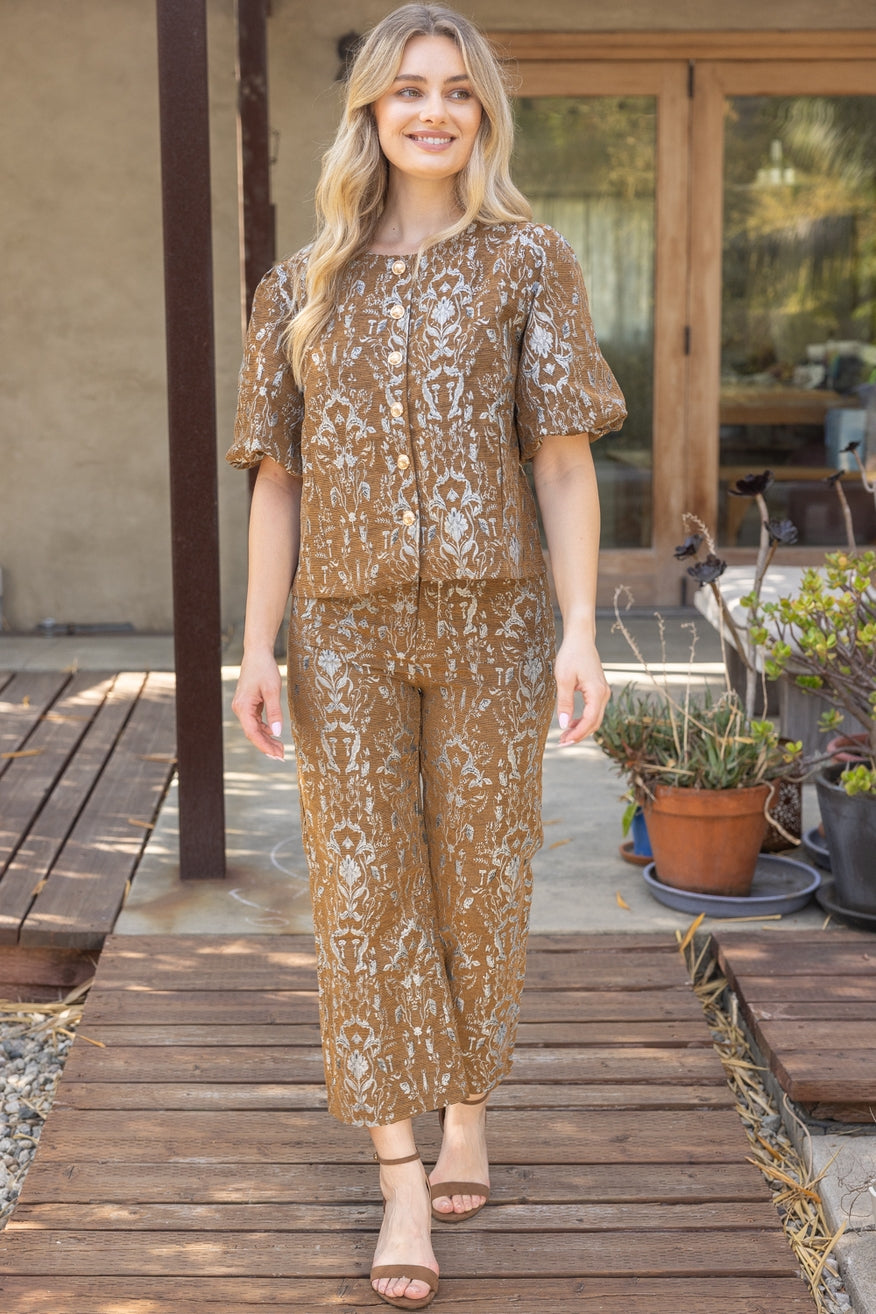 Woman wearing high-waisted brown floral jacquard pants with front pockets – Mirror On Main