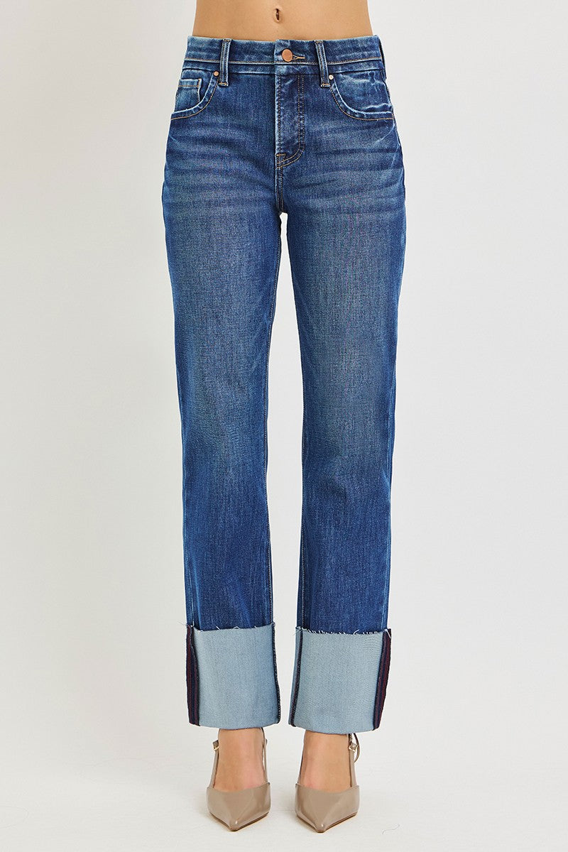 Plus size model wearing high rise medium wash ankle straight jeans with wide cuffed hem and tummy control waistband, styled with nude heels — Mirror on Main