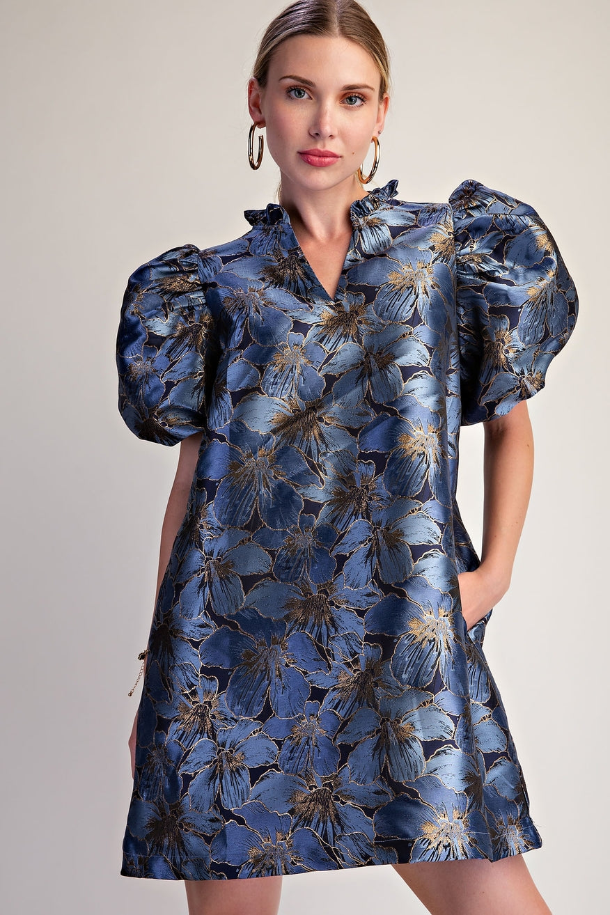 Woman wearing a metallic floral jacquard mini dress with puff sleeves and a ruffled V-neckline – Mirror On Main