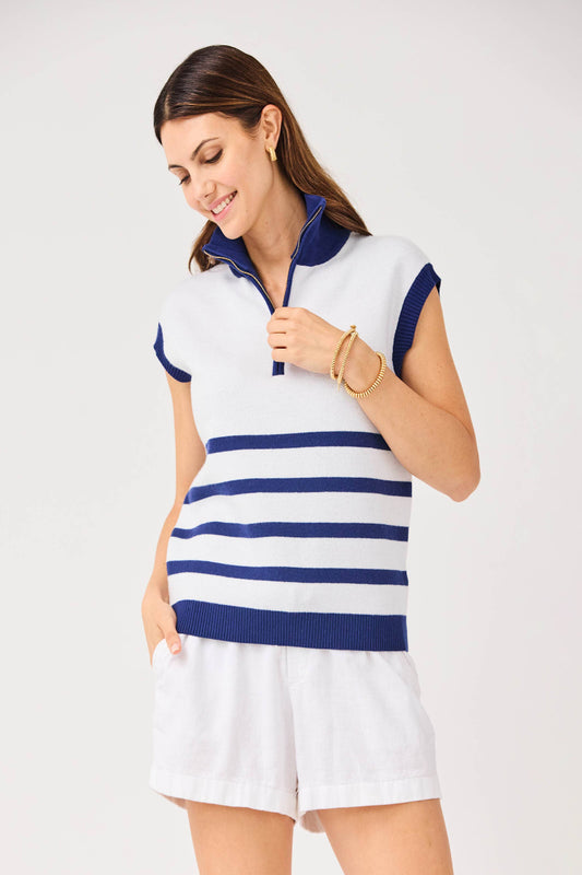 Woman wearing a white and blue striped sleeveless top with shorts on a white background