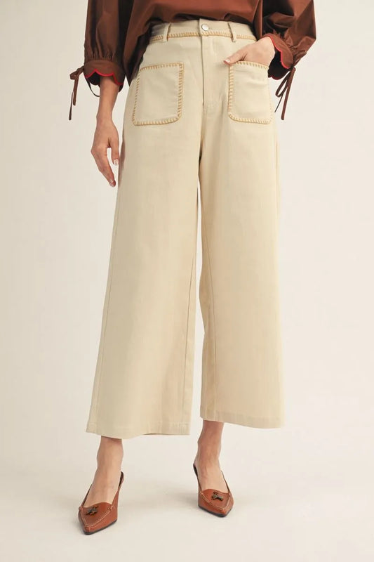 Model wearing beige high-waisted wide leg pants with contrast stitching and front patch pockets – Mirror On Main