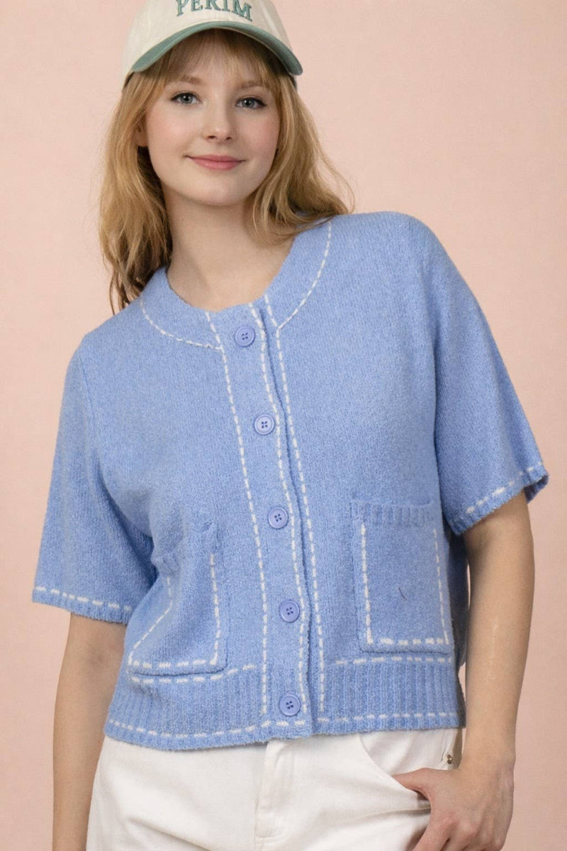 Periwinkle blue knit cardigan with contrast white topstitching at neckline, placket, pockets and ribbed hem, round neckline, short sleeves, and front patch pockets — Mirror on Main