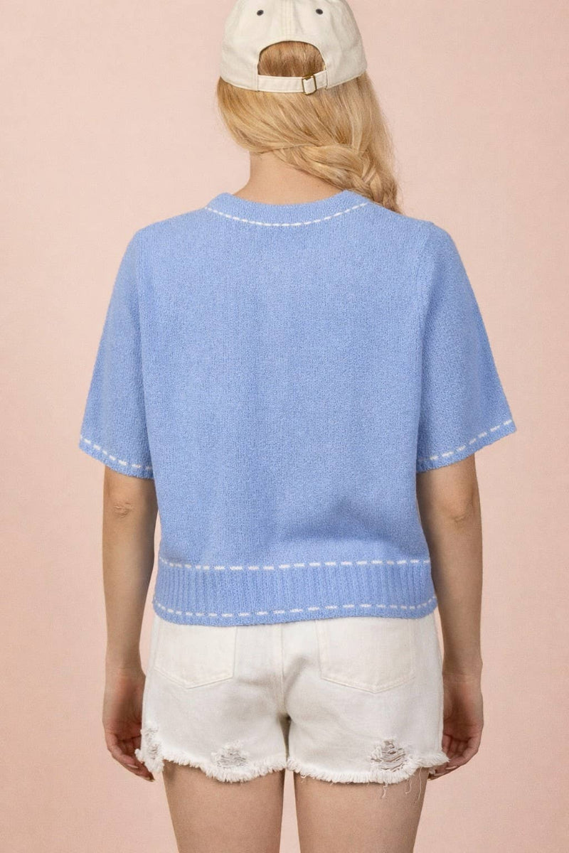 Periwinkle blue knit cardigan with contrast white topstitching at neckline, placket, pockets and ribbed hem, round neckline, short sleeves, and front patch pockets — Mirror on Main