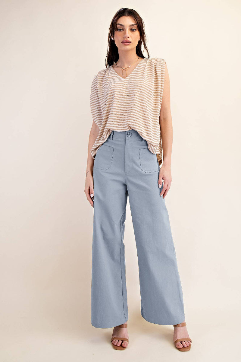 Woman wearing dusty blue high waist wide leg pants with oversized front patch pockets, styled with a striped top and tan heels — Mirror on Main