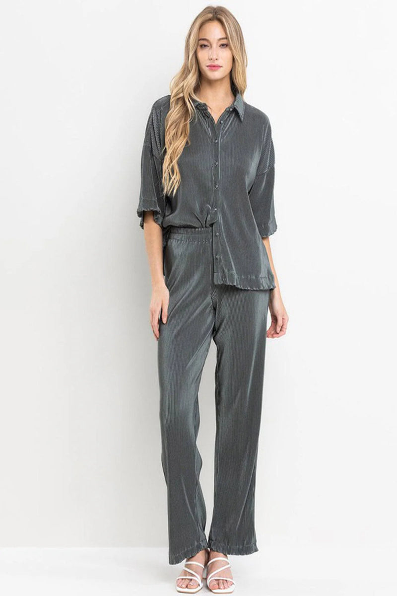 Woman wearing a gray outfit on a white background