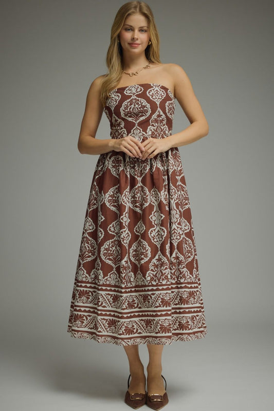 Woman wearing a chocolate brown damask print strapless midi dress with smocked back and full skirt, styled with brown heels — Mirror on Main