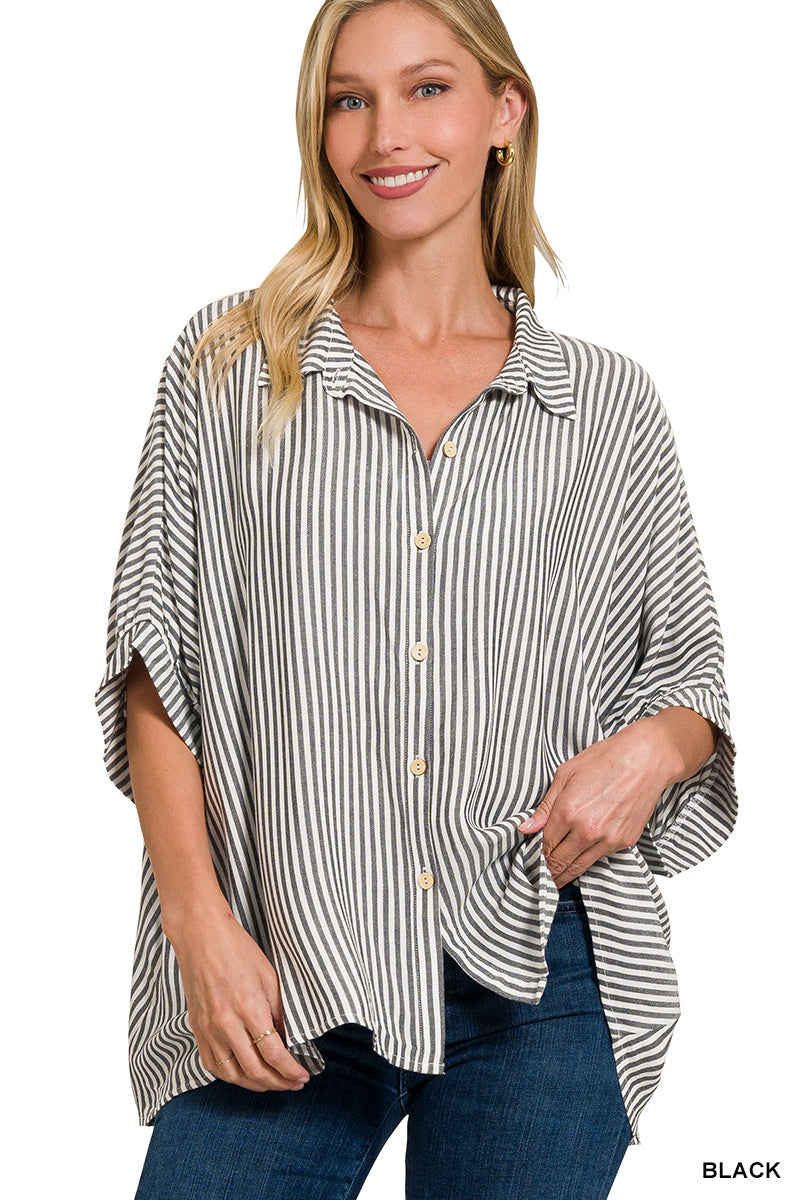 Woman wearing a black and white striped shirt with rolled-up sleeves on a white background