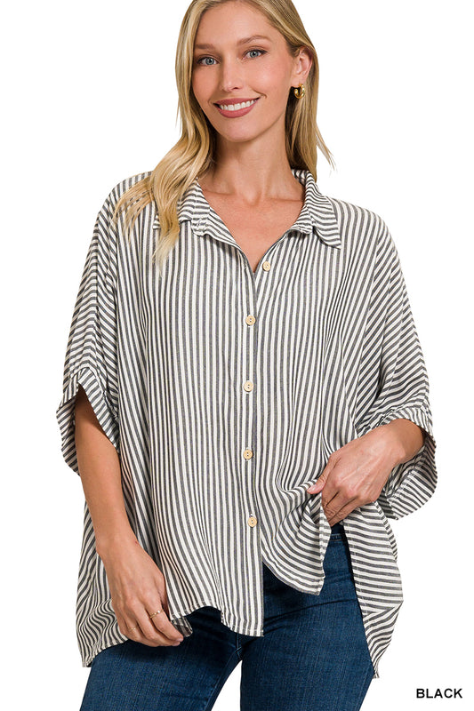 Woman wearing a black and white striped shirt with rolled-up sleeves on a white background