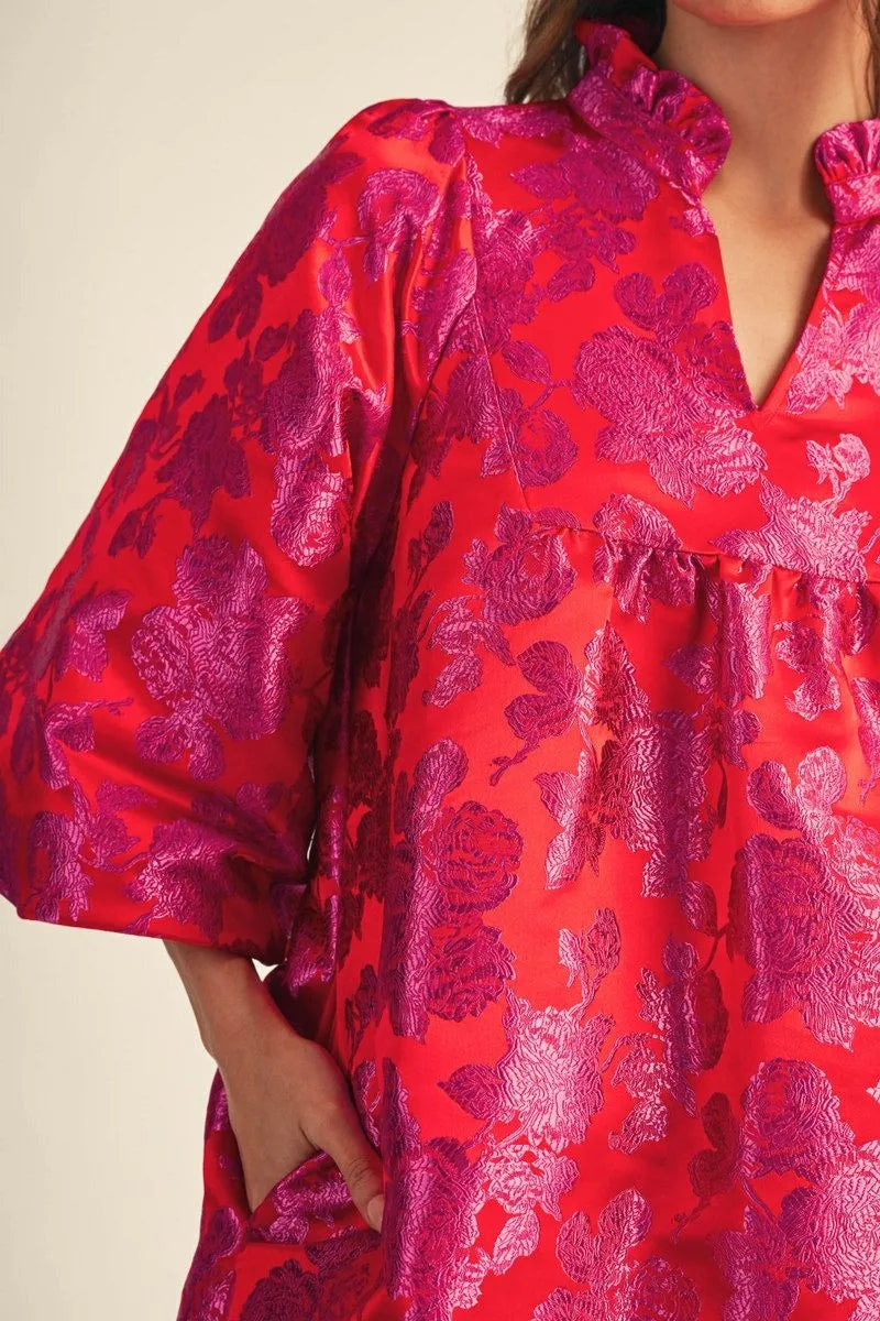 Close-up of tomato red floral jacquard dress with ruffled neckline and puff sleeves – Mirror On Main.