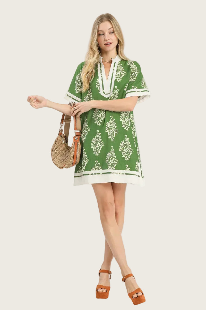 Forest green and cream two-tone abstract print tunic dress with contrast V-neckline trim, short sleeves with cuffed contrast trim, and contrast cream hem band — Mirror on Main