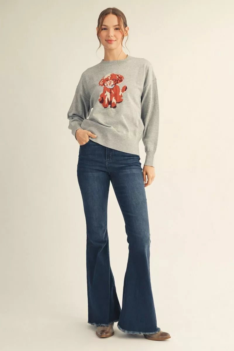 Woman wearing a heather grey puppy graphic knit sweater with long sleeves and blue jeans – Mirror On Main.