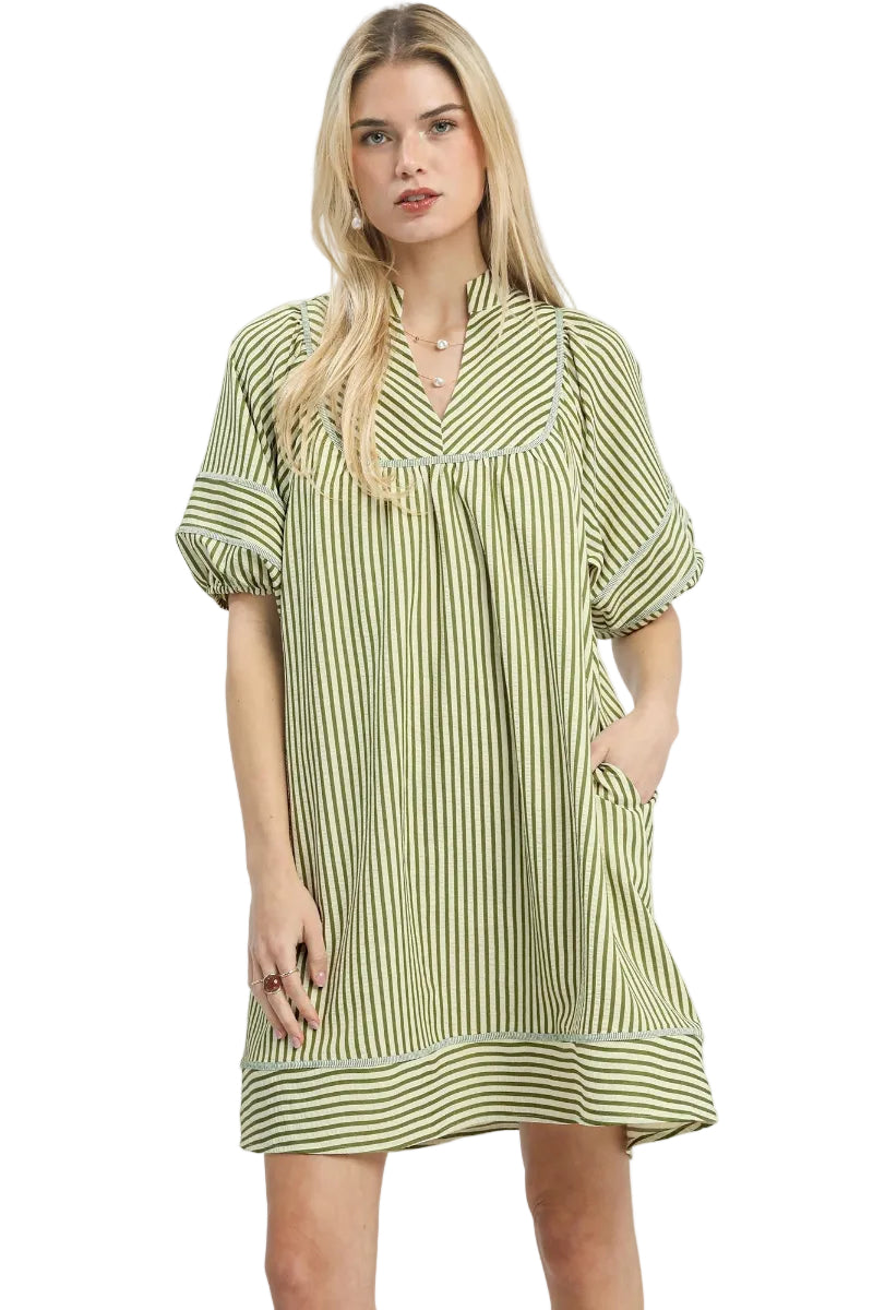 Light olive and cream vertical stripe babydoll mini dress with contrast horizontal border hem, split V-neckline, short puff sleeves with cuffed hem, and side pockets — Mirror on Main