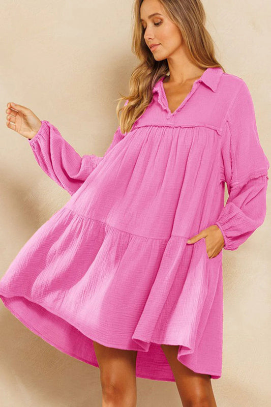 Woman wearing a pink dress against a beige background