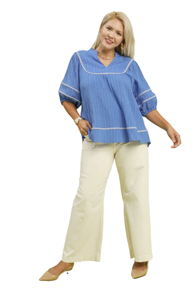 Plus size woman wearing a peri blue top with split V-neck collar, puff sleeves, and contrast trim detail — Mirror on Main