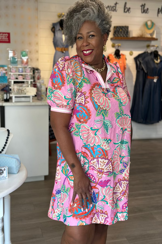 Plus size woman wearing a pink jacquard mini dress with tropical paisley print, split V-neck, and puff sleeves — Mirror on Main