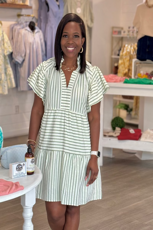 Sage green and white stripe babydoll dress with ruffled V-neckline, double flutter sleeves, and three-tiered lined skirt above the knee — Mirror on Main
