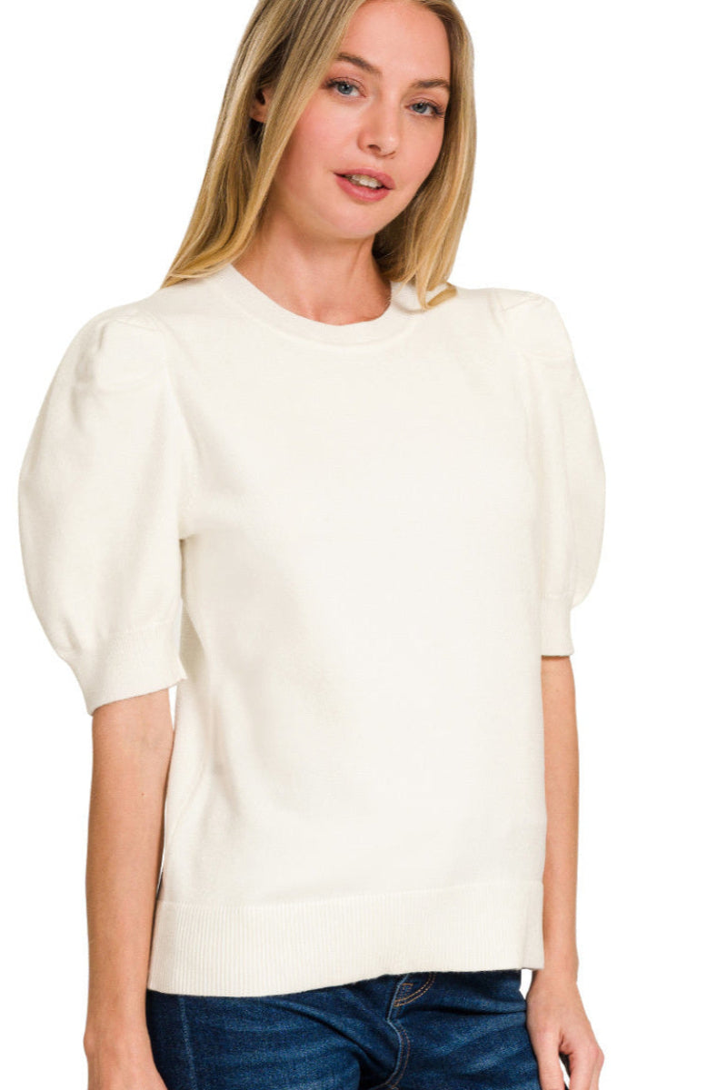 Woman wearing a white blouse with puffed sleeves on a white background