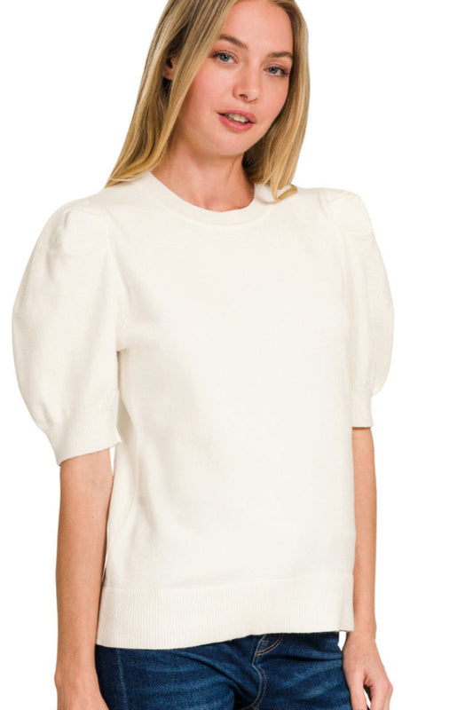 Woman wearing a white blouse with puffed sleeves on a white background