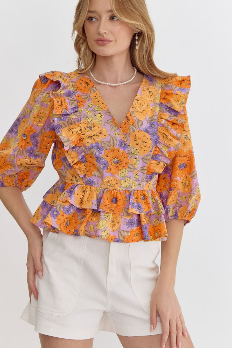 floral ruffle peplum top in multiple colors styled with white shorts for spring outfit