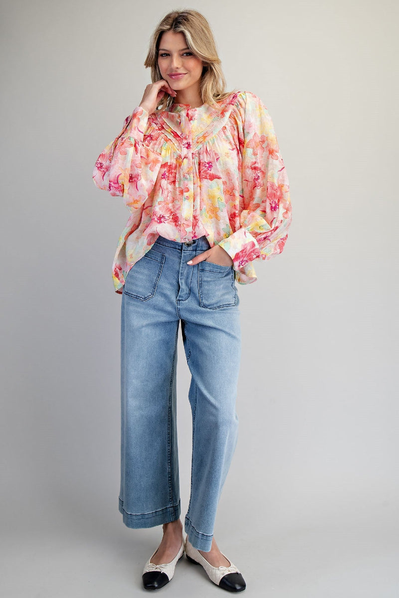 watercolor floral blouse with pintuck detail and balloon sleeves styled with denim