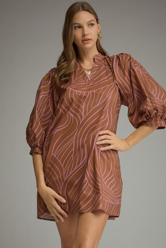 Woman wearing a cocoa brown shift mini dress with lilac swirl print, split V-neck and 3/4 balloon sleeves – Mirror On Main
